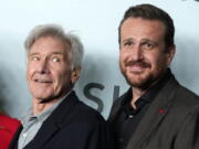 Harrison Ford, left, a cast member in "Shrinking," looks over at castmate Jason Segel at the premiere of the Apple TV+ comedy series in Los Angeles.