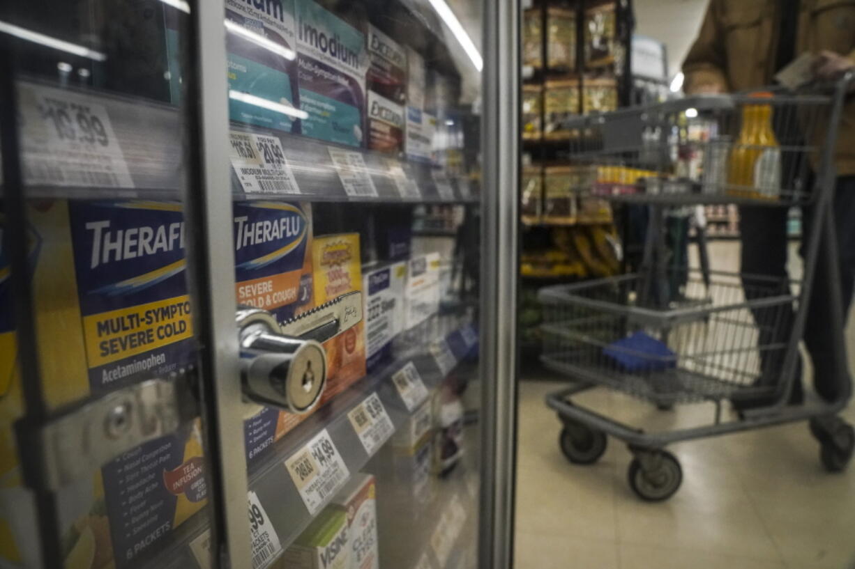 Pharmaceutical items are kept locked in a glass cabinet at a Gristedes supermarket, Tuesday Jan. 31, 2023, in New York. Increasingly, retailers are locking up more products or increasing the number of security guards at their stores to curtail theft.