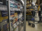 Pharmaceutical items are kept locked in a glass cabinet at a Gristedes supermarket, Tuesday Jan. 31, 2023, in New York. Increasingly, retailers are locking up more products or increasing the number of security guards at their stores to curtail theft.