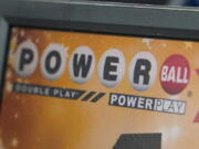 FILE - A display panel advertises tickets for a Powerball drawing at a convenience store, Nov. 7, 2022, in Renfrew, Pa. Someone in Washington state overcame steep odds Monday night, Feb. 6, 2023, to win an estimated $747 million Powerball jackpot. Lottery officials did not immediately make an announcement of a winner, but the Powerball website says there was a jackpot winner in the state.