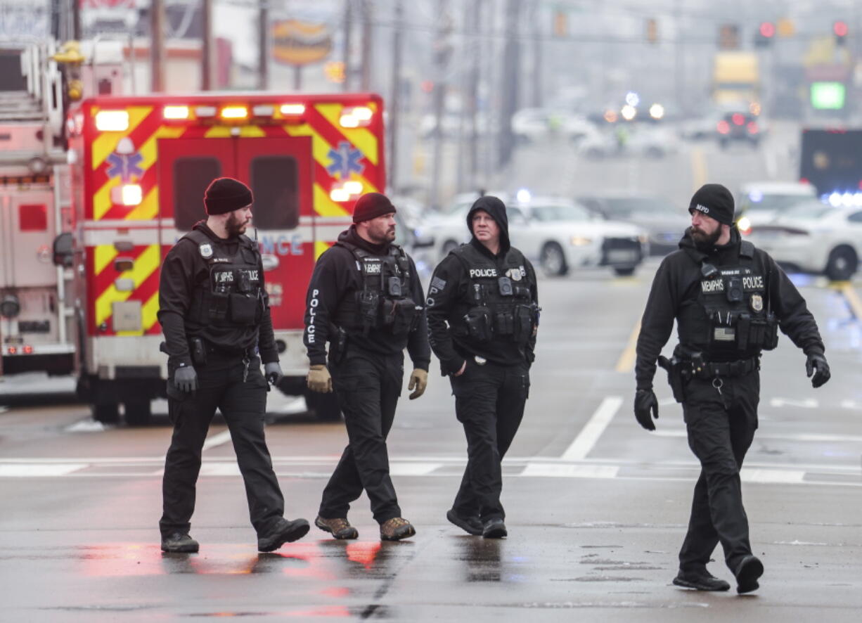 Law enforcement personnel work at the scene of a shooting at a Tennessee library, Thursday, Feb. 2, 2023, in Memphis.  Authorities say one person is dead and a police officer was critically wounded.