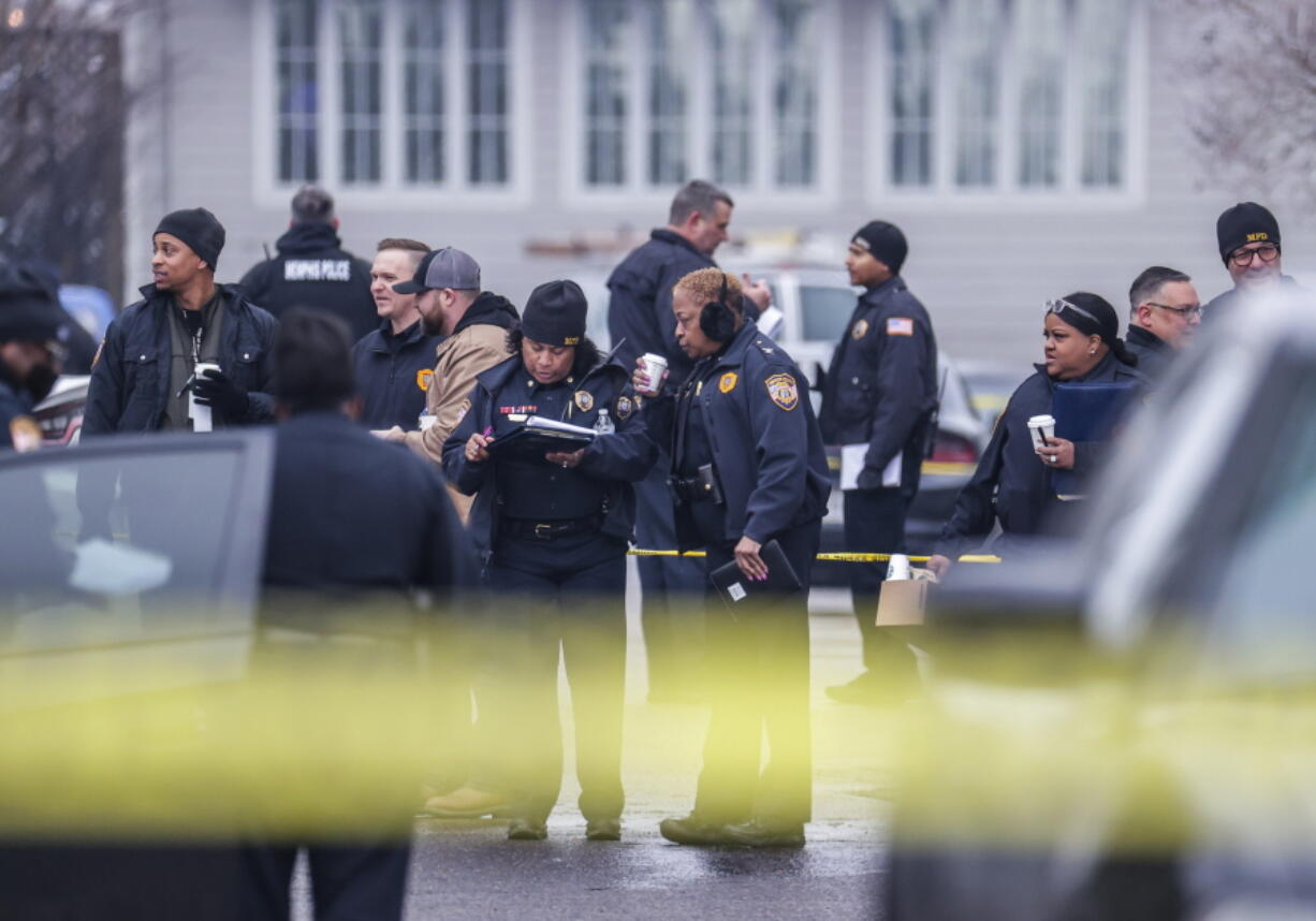 Law enforcement personnel work at the scene of a shooting at a Tennessee library, Thursday, Feb. 2, 2023, in Memphis.  Authorities say one person is dead and a police officer was critically wounded.