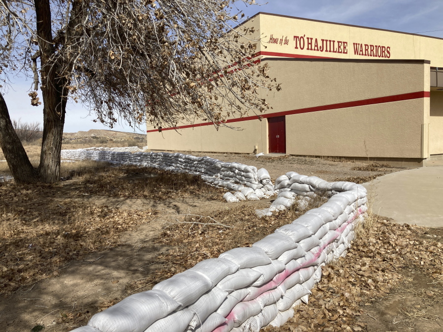 This Feb. 17, 2023 image shows a wall of sandbags protecting the school in the Navajo community of To'Hajiilee, New Mexico. To'Hajiilee Community School is just one of dozens funded by the U.S. Bureau of Indian Education that are in desperate need of repair or replacement. The agency estimates it would cost roughly $6.2 billion to address the needs of those schools in poor condition.