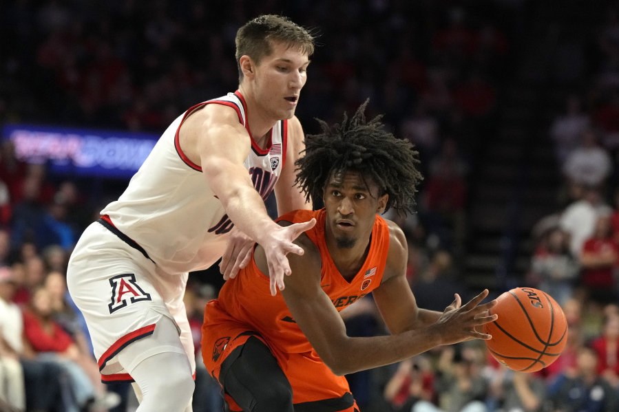 Oregon State forward Glenn Taylor Jr., right, shields the ball from Arizona forward Azuolas Tubelis during the first half of an NCAA college basketball game, Saturday, Feb. 4, 2023, in Tucson, Ariz.