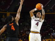 Arizona State's Desmond Cambridge Jr. looks to shoot over Oregon State's Dexter Akanno, left, during the second half of an NCAA college basketball game, Thursday, Feb. 2, 2023, in Tempe, Ariz.