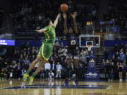 Washington guard Keyon Menifield shoots over Oregon guard Will Richardson during the second half of an NCAA college basketball game Wednesday, Feb. 15, 2023, in Seattle.
