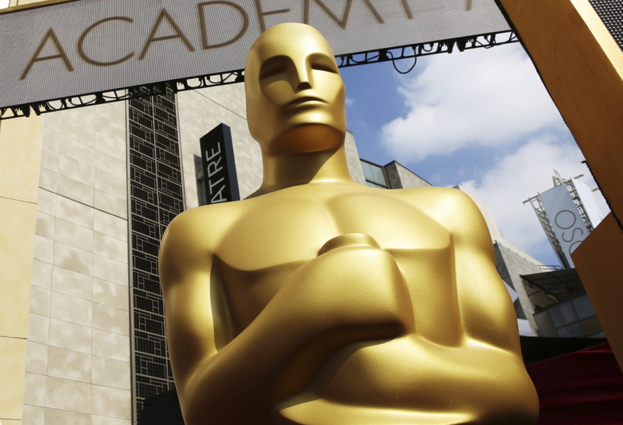 FILE - In this Feb. 21, 2015 file photo, an Oscar statue appears outside the Dolby Theatre for the 87th Academy Awards in Los Angeles. This year's Oscars will be held Sunday, March 12. The ceremony is set to begin at 8 p.m. EST and be broadcast live on ABC. Jimmy Kimmel will host for the third time and his first time since 2018.