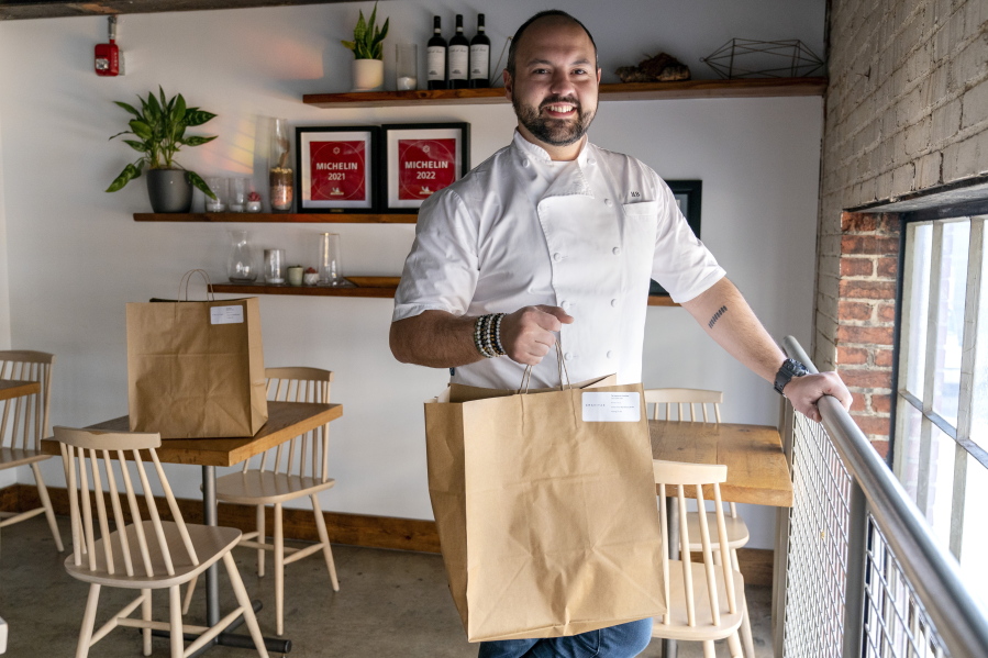 Matt Baker, chef and owner of Gravitas, poses for a portrait inside the restaurant, Tuesday, Feb. 14, 2023, in Washington. Gravitas has a subscription service offering a monthly meal for two.