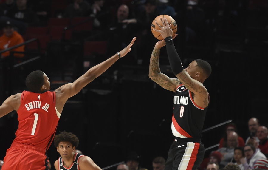 Portland Trail Blazers guard Damian Lillard, right, hits a basket over Houston Rockets forward Jabari Smith Jr., left, during the first half of an NBA basketball game in Portland, Ore., Sunday, Feb. 26, 2023.
