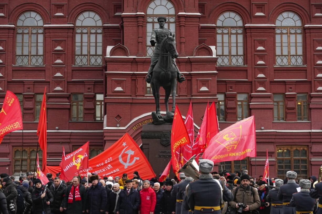 Communist's party supporters with Red flags gather around the statue of Soviet Marshal Georgy Zhukov after a wreath-laying ceremony at the Tomb of the Unknown Soldier near the Kremlin Wall attending commemorations marking the 80th anniversary of the Soviet victory in the battle of Stalingrad in Moscow, Russia, Thursday, Feb. 2, 2023. The battle of Stalingrad turned the tide of World War II and is regarded as the bloodiest battle in history, with the death toll for soldiers and civilians estimated at about 2 millions.