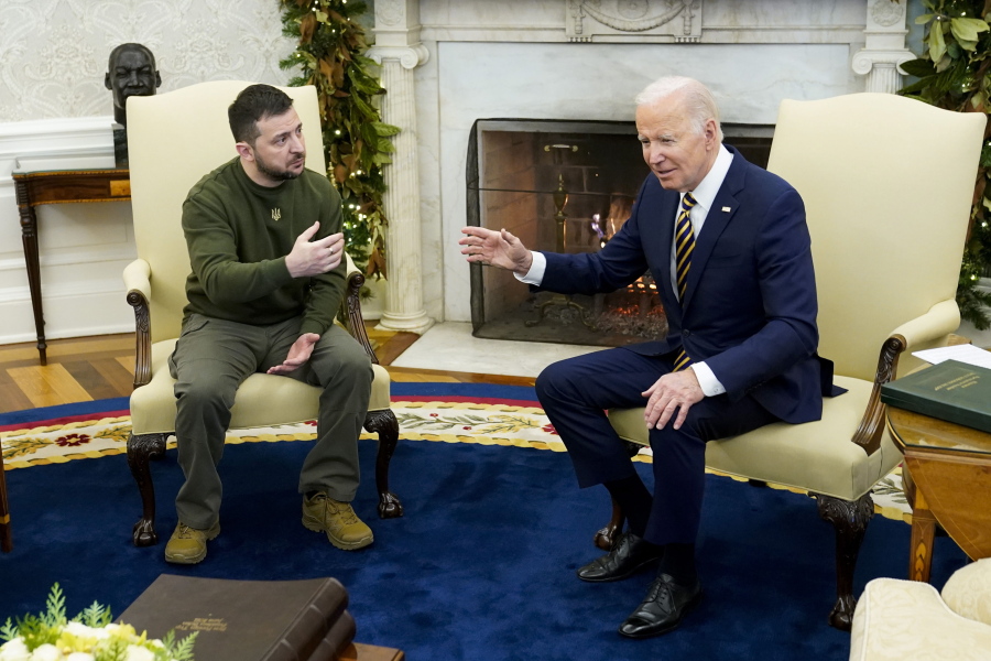 FILE - President Joe Biden speaks with Ukrainian President Volodymyr Zelenskyy as they meet in the Oval Office of the White House, Dec. 21, 2022, in Washington. One year ago, Biden braced for the worst as Russia massed troops in preparation to invade Ukraine. But as Russia's deadly invasion reaches the one year mark, Kyiv stands and Ukraine has exceeded even its own expectations.