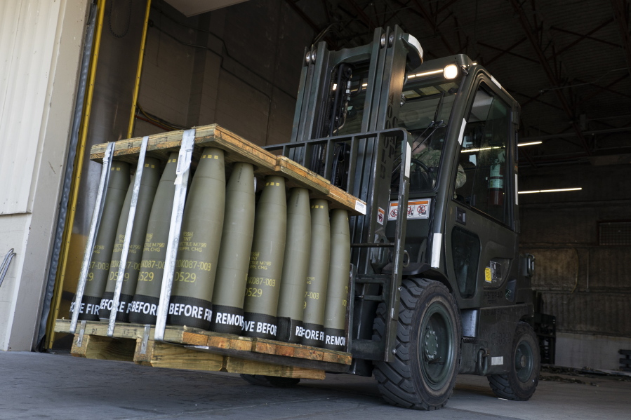 FILE - Airmen with the 436th Aerial Port Squadron use a forklift to move 155 mm shells ultimately bound for Ukraine, April 29, 2022, at Dover Air Force Base, Del. The Pentagon announced a new package of long-term security assistance for Ukraine on Friday, Feb. 24, 2023, marking the one-year anniversary of Russia's invasion with a $2 billion commitment to send more rounds of ammunition and a variety of small, high-tech drones into the fight.