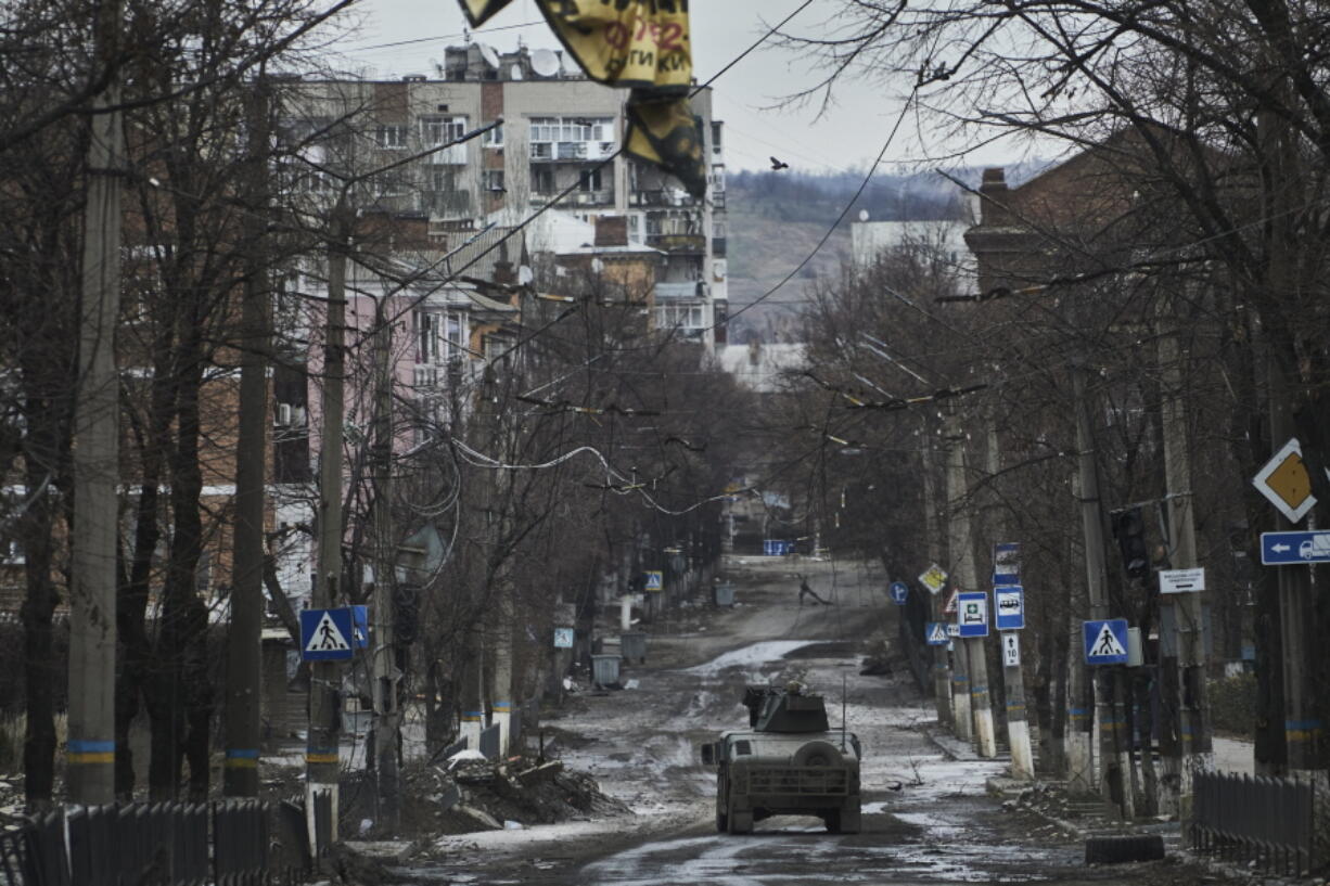 FILE - Ukrainian soldiers ride in a Humvee in Bakhmut, Donetsk region, Ukraine, Wednesday, Dec. 21, 2022.