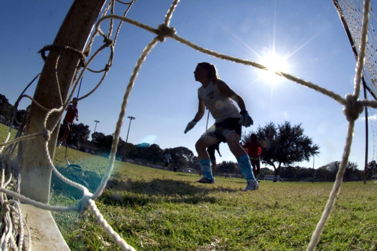 FILE - The goalkeeper guards the net as girls take part in the first day of tryouts for the Fort Walton Beach High School girls' soccer team in Fort Walton Beach, Fla., on Oct. 10, 2012. Facing blowback, the leader of Florida's high school sports association is backing away from using a permission form that requires female athletes to disclose their menstrual history. The association's board is meeting Thursday, Feb. 9, 2023, to vote on whether to adopt a new recommendation that most personal information revealed on a medical history form be left at the doctor's office and not stored at school.