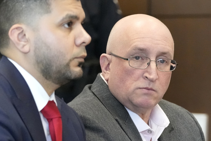 Robert E. Crimo Jr., right, and his attorney George Gomez, appear before Judge George D. Strickland at the Lake County Courthouse, Thursday, Feb. 16, 2023, in Waukegan, Ill. Crimo, the father of a man charged with fatally shooting seven people at a Fourth of July parade in suburban Chicago, entered a not guilty plea to charges that he helped his son obtain a gun license years before the attack. (AP Photo/Nam Y.