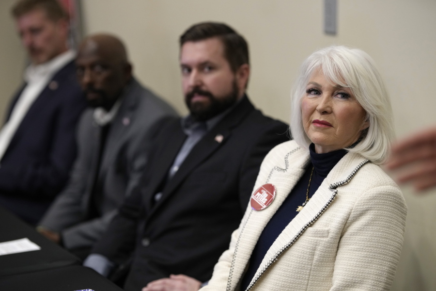 Candidate for the Colorado Republican Party chair position Tina Peters, right, and fellow candidates from left, Erik Aadland, Casper Stockham and Aaron Wood, listen during a debate sponsored by the Republican Women of Weld, Saturday, Feb. 25, 2023, in Hudson, Colo.