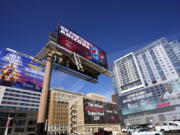 Large advertisements adorn buildings and electronic billboards leading up to the NFL Super Bowl LVII football game in Phoenix, Friday, Feb. 3, 2023. (AP Photo/Ross D.