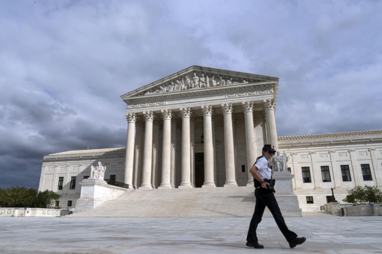 A U.S. Supreme Court police officer walks by during a voting rights rally, at the Supreme Court Oct. 28, 2021, in Washington. Supreme Court police officers are looking for a few good men and women -- as are law enforcement departments around the country in a tight employment market.