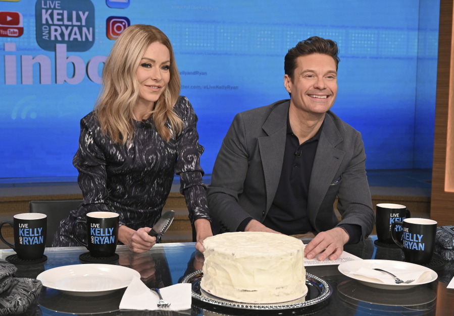 This image released by ABC shows co-host Kelly Ripa, left, and Ryan Seacrest on the set of "Live! With Kelly and Ryan" on Feb. 8, 2023 in New York. Seacrest has revealed he's leaving the show this spring. Seacrest ends a six-year run alongside Ripa and his replacement will be her real-life husband, Mark Consuelos.