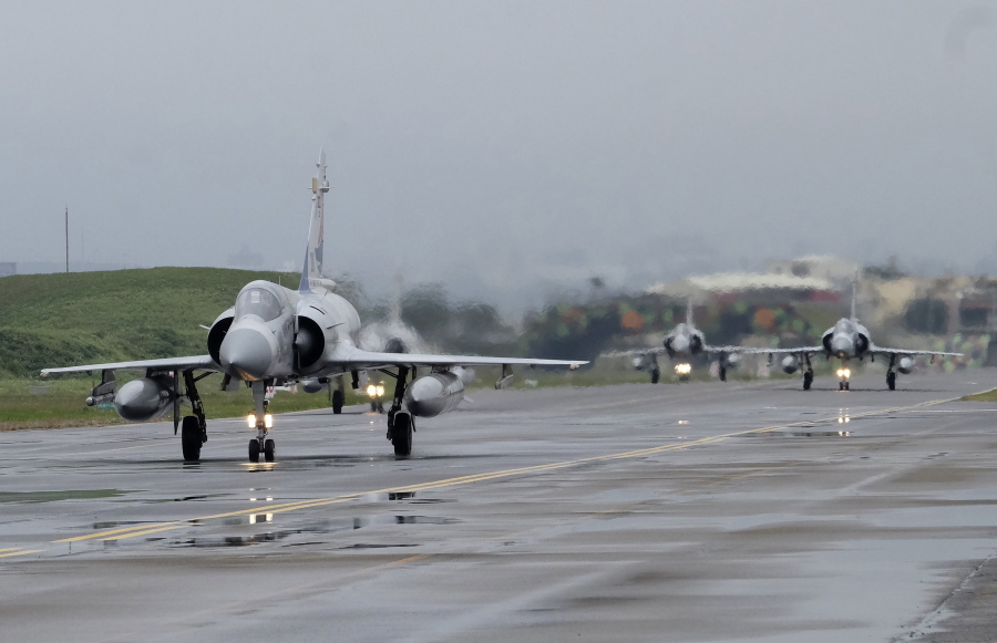 FILE - Taiwanese Mirage 2000 fighter jets taxi along a runway during a drill at an airbase in Hsinchu, Taiwan, Wednesday, Jan. 11, 2023. Taiwan scrambled fighter jets, put its navy on alert and activated missile systems Tuesday, Jan. 31, 2023, in response to nearby operations of 34 Chinese military aircraft and nine warships that are part Beijing's strategy to unsettle and intimidate the self-governing island democracy.