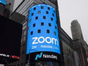 FILE - This April 18, 2019, file photo shows a sign for Zoom Video Communications ahead of the company's Nasdaq IPO in New York.  The video-conferencing service is cutting about 1,300 jobs, or approximately 15 percent of its workforce. CEO Eric Yuan said in a blog post Tuesday, Feb. 7, 2023, that the company ramped up staffing during the COVID-19 pandemic, when businesses became increasingly reliant on its service as people worked from home. Yuan said Zoom grew three times in size within 24 months to manage demand.