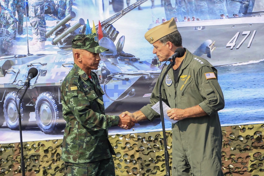 In this photo released by Royal Thai Army, Thailand Chief of Defence Forces General Chalermpol Srisawasdi, left, shakes hands with Commander of the United States Indo-Pacific Command Admiral John Aquilino, during opening ceremony of Cobra Gold 2023 in Rayong Province Thailand, Tuesday, Feb. 28, 2023. Thai and U.S. officials presided over the opening ceremony Tuesday of Cobra Gold 2023, one of the biggest joint multilateral military exercises in the world that pulls together the security interests of the United States and six Asian nations.