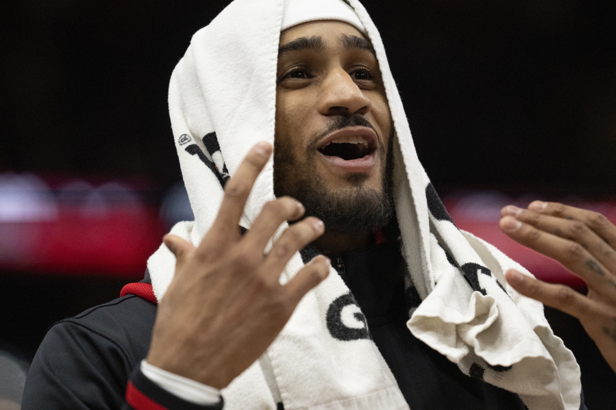 Portland Trail Blazers guard Gary Payton II wears a towel over his head during the second half of an NBA basketball game against the Chicago Bulls, Saturday, Feb. 4, 2023, in Chicago.