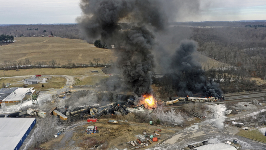 FILE - This photo taken with a drone shows portions of a Norfolk Southern freight train that derailed Friday night in East Palestine, Ohio are still on fire at mid-day Saturday, Feb. 4, 2023. Toxic wastewater used to extinguish a fire following a train derailment in Ohio is headed to a Houston suburb for disposal. Harris County Judge Lina Hidalgo says "firefighting water" from the East Palestine, Ohio train derailment is to be disposed of in the county and she is seeking more information.(AP Photo/Gene J.