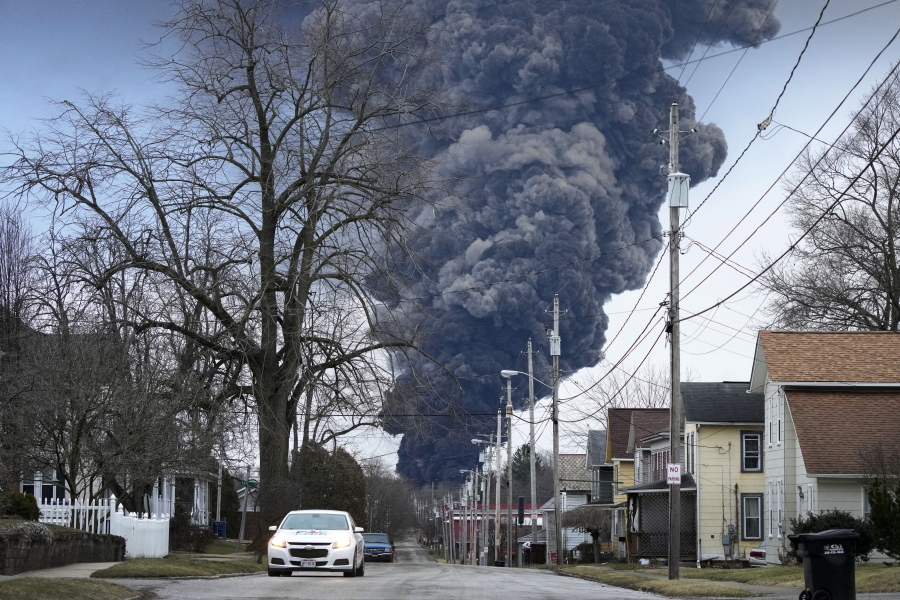 FILE - A black plume rises over East Palestine, Ohio, as a result of a controlled detonation of a portion of the derailed Norfolk Southern trains, on Feb. 6, 2023. Transportation Secretary Pete Buttigieg announced a package of reforms to improve safety Tuesday, Feb. 21 -- two days after he warned the railroad responsible for the derailment, Norfolk Southern, to fulfill its promises to clean up the mess just outside East Palestine, and help the town recover. (AP Photo/Gene J.