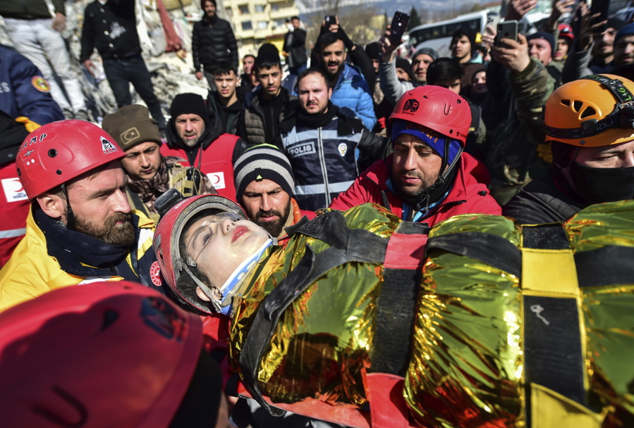 Rescuers carry Zeynep Polat, pulled out from a collapsed building days after the earthquake, in Kahramanmaras, southern Turkey, Thursday, Feb. 9, 2023. Thinly stretched rescue teams worked through the night in Turkey and Syria, pulling more bodies from the rubble of thousands of buildings toppled by a catastrophic earthquake.