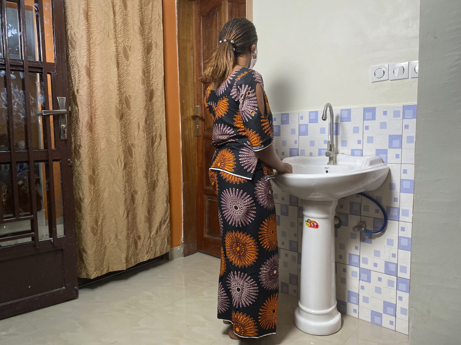 FILE - In this Anifa stands in her home in the eastern Congo town of Goma on Friday, March 5, 2021. Two experts appointed by the World Health Organization to investigate allegations that some of its staffers sexually abused women during an Ebola outbreak in Congo have dismissed the U.N.