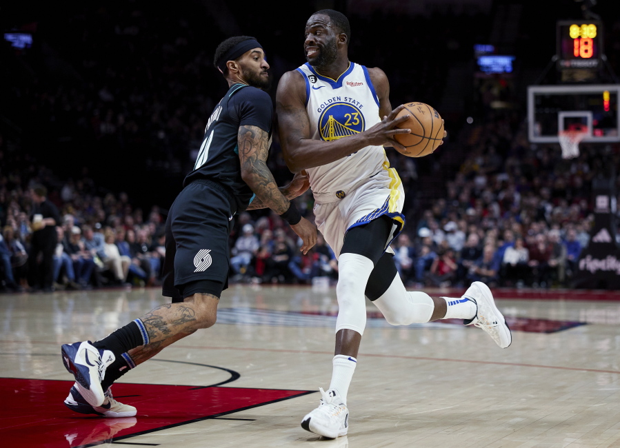 Golden State Warriors forward Draymond Green drives to the basket past Portland Trail Blazers guard Gary Payton II during the first half of an NBA basketball game in Portland, Ore., Wednesday, Feb. 8, 2023.