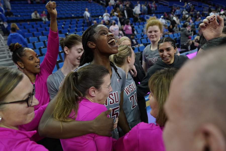 Washington State center Bella Murekatete (55) celebrates with teammates after a 62-55 win over UCLA in an NCAA college basketball game in Los Angeles, Thursday, Feb. 23, 2023.