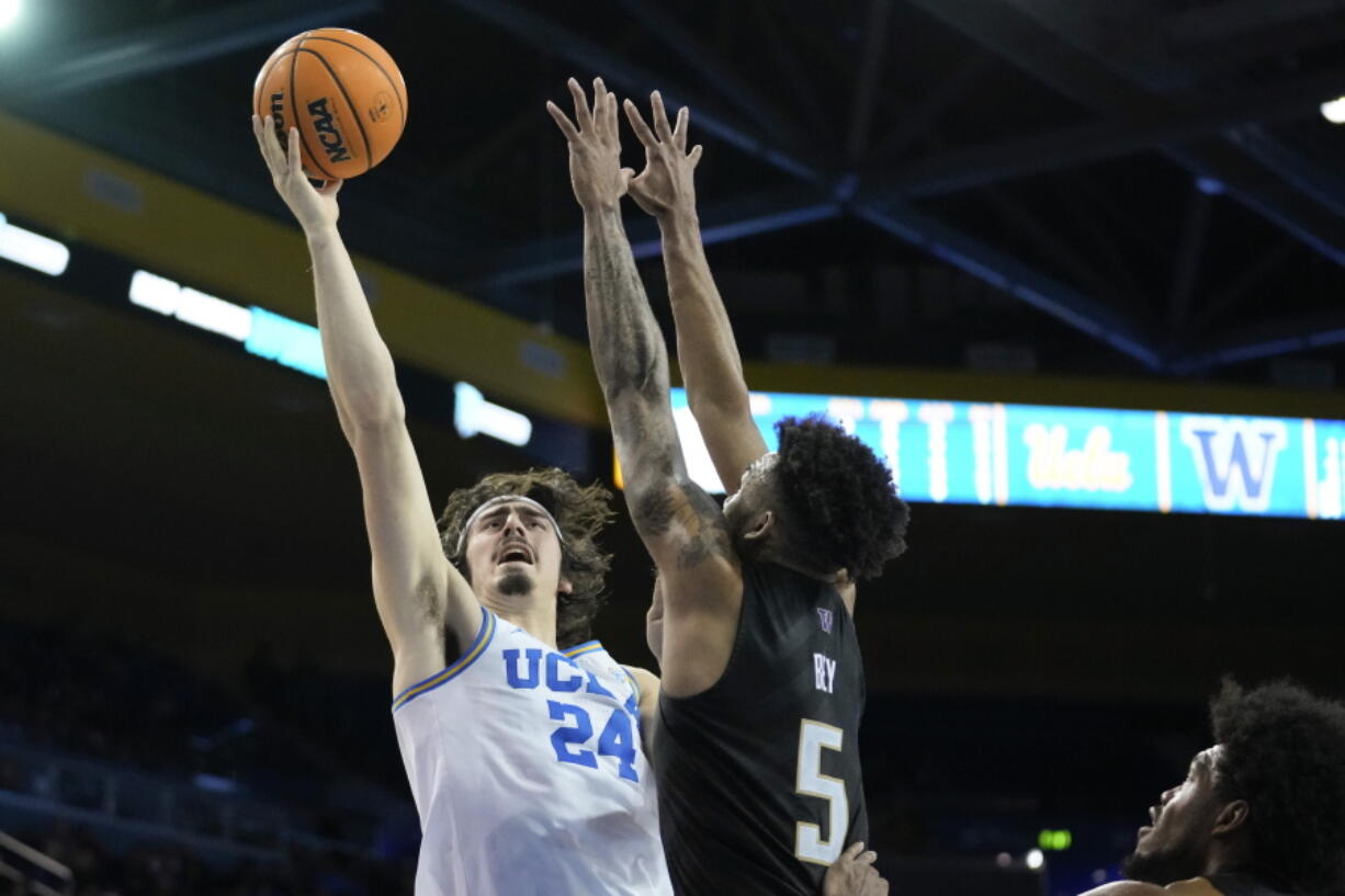 UCLA guard Jaime Jaquez Jr. (24) shoots against Washington guard Jamal Bey (5) during the second half of an NCAA college basketball game in Los Angeles, Thursday, Feb. 2, 2023.