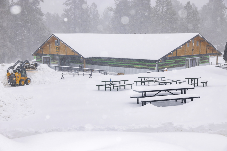 In this photo provided by Big Bear Mountain Resort, snow falls at the resort in Big Bear, Calif., Saturday, Feb. 25, 2023.