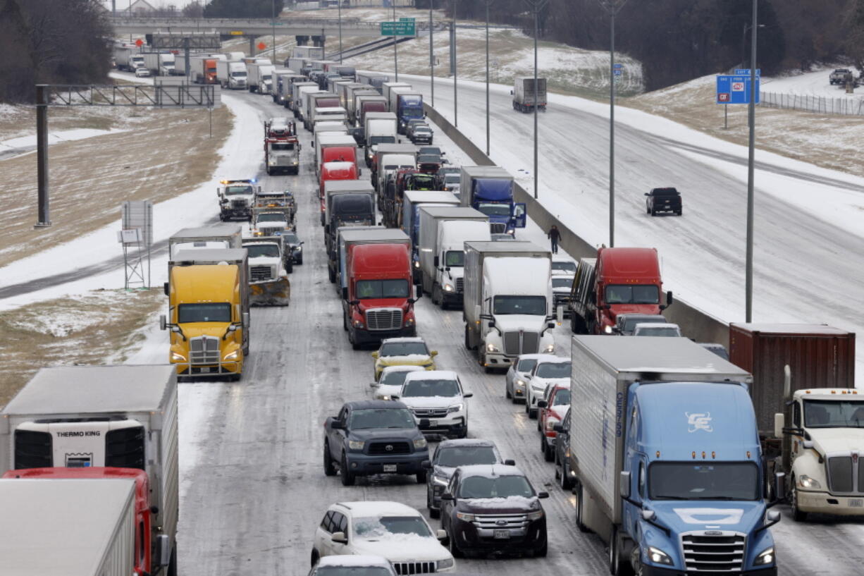 Traffic sits at a standstill along westbound I-20 near Cedar Ridge Drive and Loop 408 in Dallas, Tuesday, Jan. 31, 2023. Several vehicles, including semi-trucks, were unable to make it up a hill causing traffic to stop.