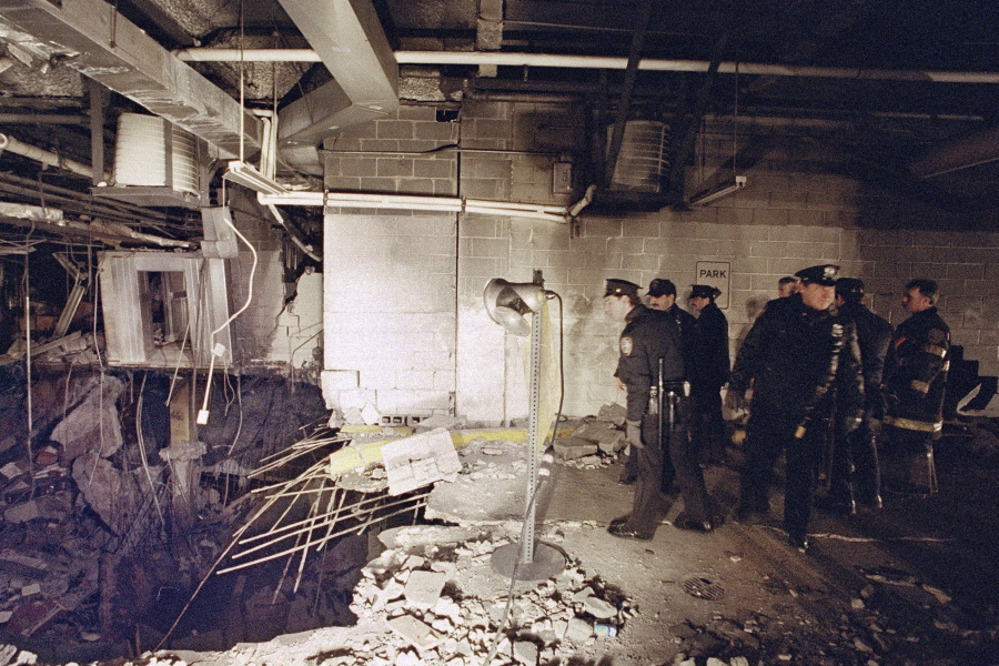 FILE - New York City police and firefighters inspect the bomb crater inside an underground parking garage of New York's World Trade Center on Feb. 27, 1993, the day after an explosion tore through it. Thirty years after terrorism first struck the World Trade Center, victims' relatives and survivors are gathering to commemorate the deadly 1993 bombing that foreshadowed 9/11.