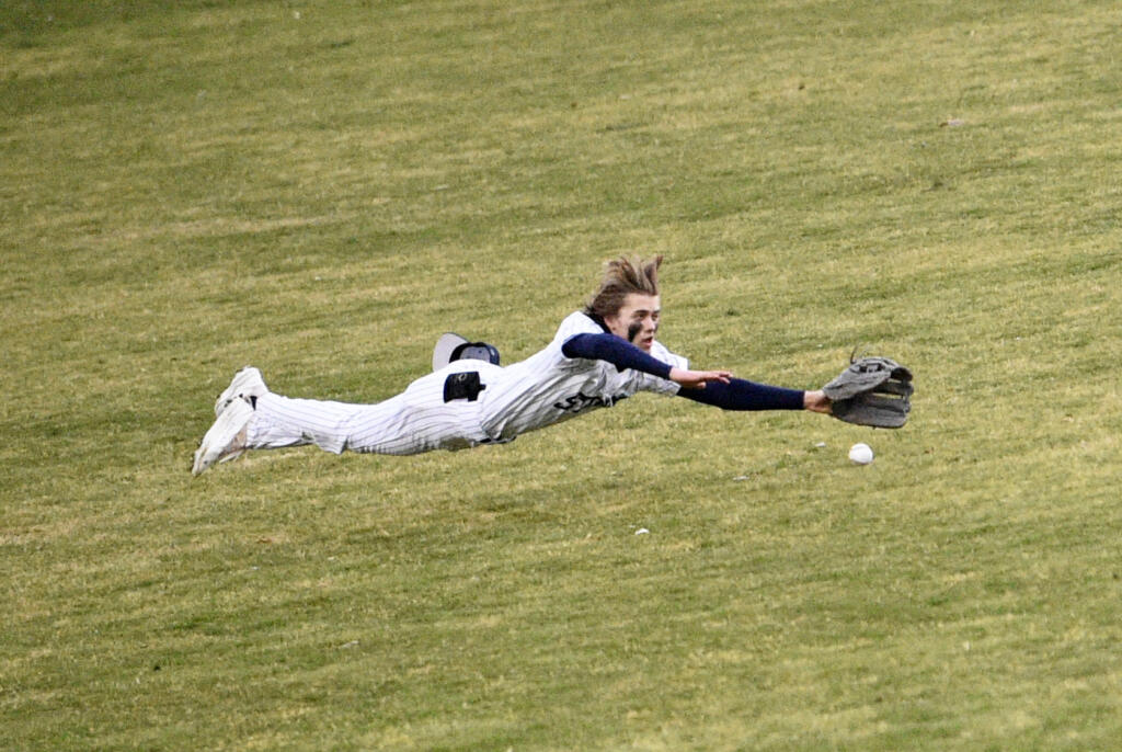 Skyview left fielder Micah Robison makes a diving attempt on a ball hit by Chanz Flores of Hudson’s Bay in the sixth inning of a season-opening high school baseball game at Propstra Stadium on Friday, March 10, 2023.