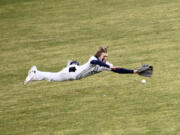 Skyview left fielder Micah Robison makes a diving attempt on a ball hit by Chanz Flores of Hudson’s Bay in the sixth inning of a season-opening high school baseball game at Propstra Stadium on Friday, March 10, 2023.
