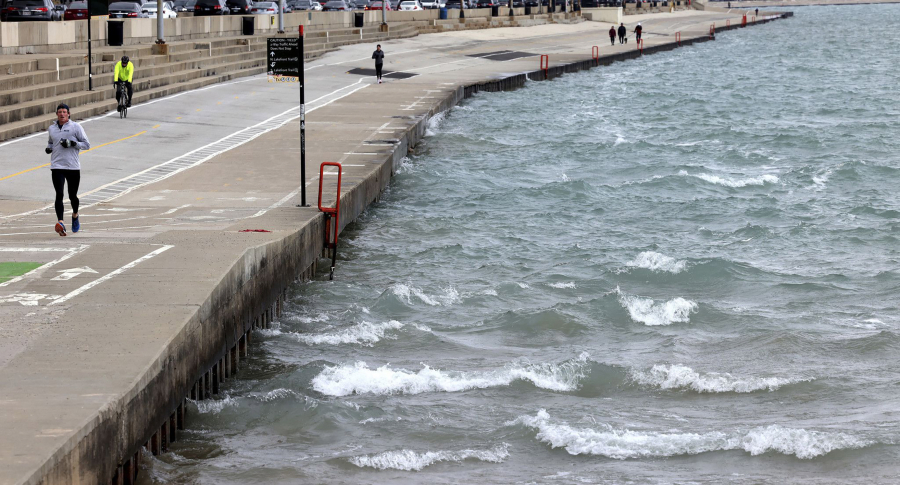 A man jogs March 2 as small waves break along Lake Michigan at Ohio Street Beach in Chicago.