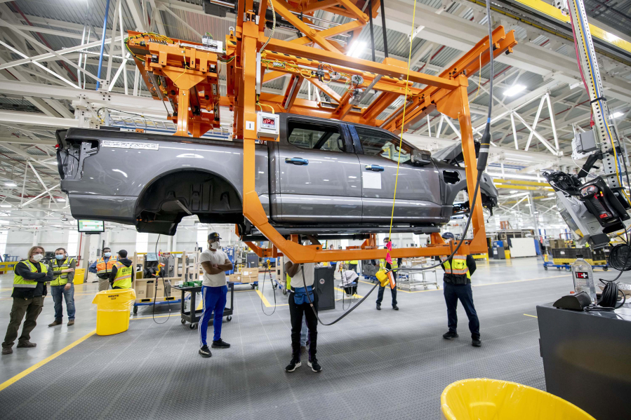 Ford employees assemble the Ford F-150 Lightning at the Ford Rouge Electric Vehicle Center, in Dearborn, Michigan, on March 2, 2022. The fully electric truck is expected to go on sale to the general public in the spring.