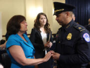 Democratic Representative from New Hampshire Ann McLane Kuster (left) reacts as she speaks with Sgt. Aquilino Gonell of the US Capitol Police after he testified during the Select Committee to Investigate the January 6th Attack on the US Capitol adjourned their first hearing on Capitol Hill in Washington, D.C., on July 27, 2021.