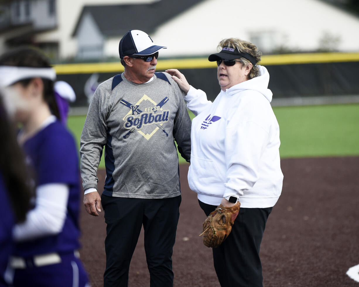 Former Heritage athletic director Leta Meyer, right, talks with Kelso coach Dean Sorenson prior to the first Heritage fastpitch softball game played at the school's new turfed field facility on Tuesday, March 14, 2023 (Tim Martinez/The Columbian)