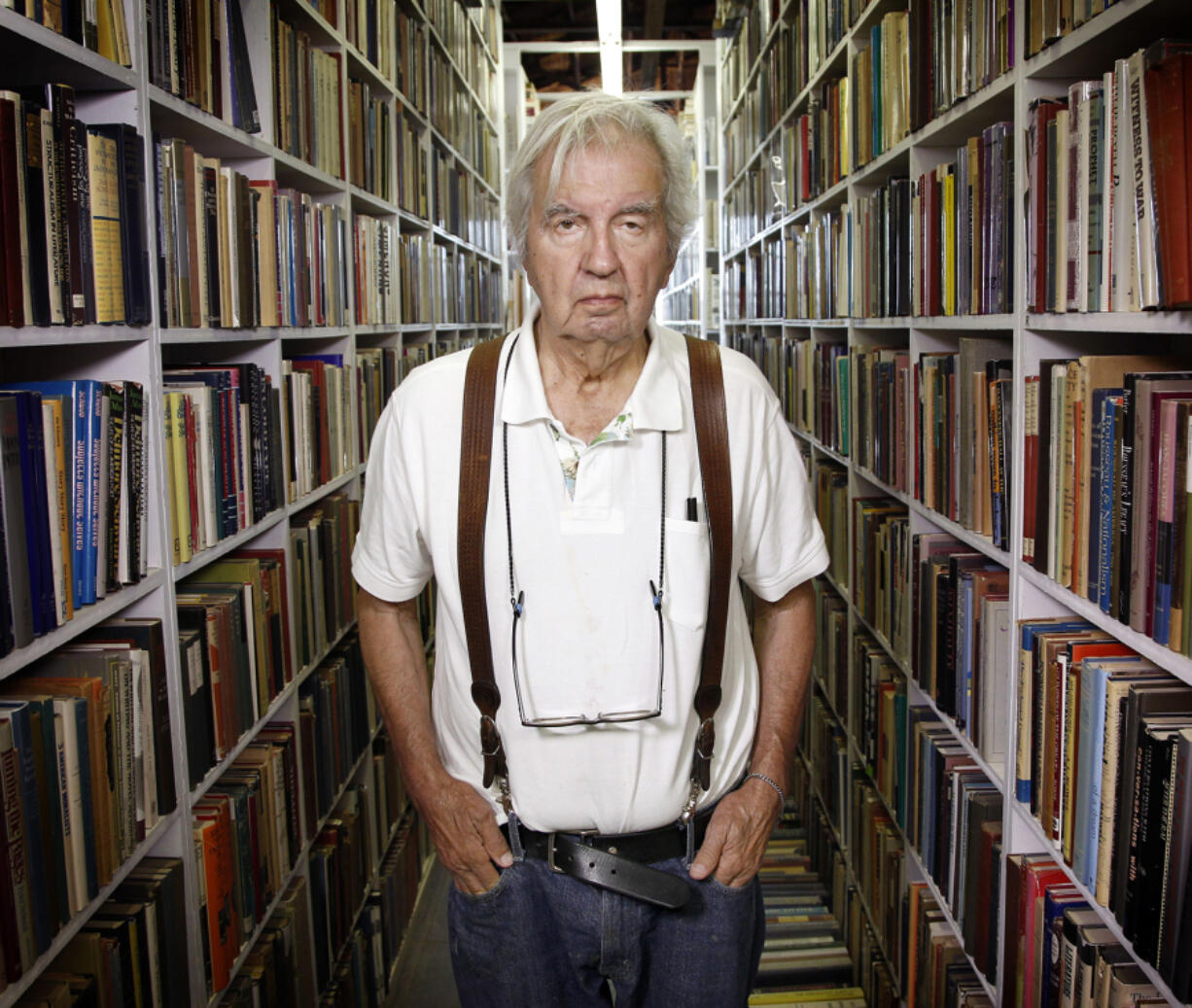 Author Larry McMurtry stands in his Archer City bookstore during a liquidation sale in 2012.