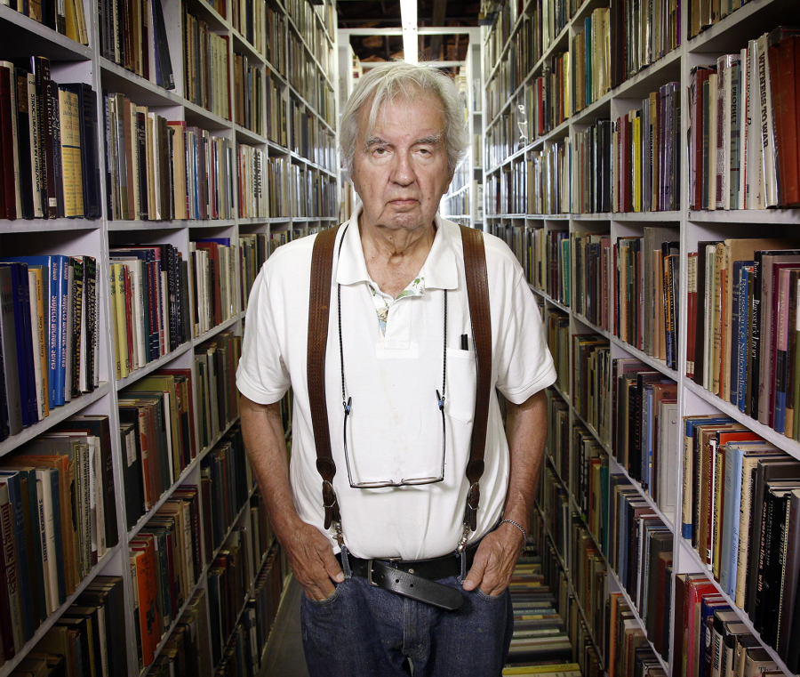 Author Larry McMurtry stands in his Archer City bookstore during a liquidation sale in 2012.