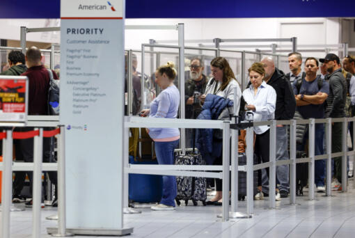 Passengers wait in line at a TSA security checkpoint inside Terminal C at DFW International Airport, Wednesday, March 1, 2023.
