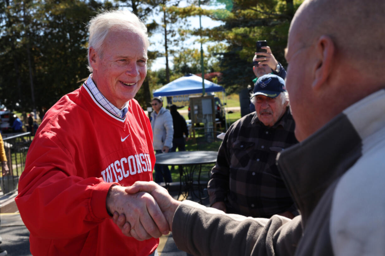Sen. Ron Johnson, R-Wis., greets people during a campaign stop at the Moose Lodge Octoberfest celebration on Oct. 8, 2022, in Muskego, Wisconsin.