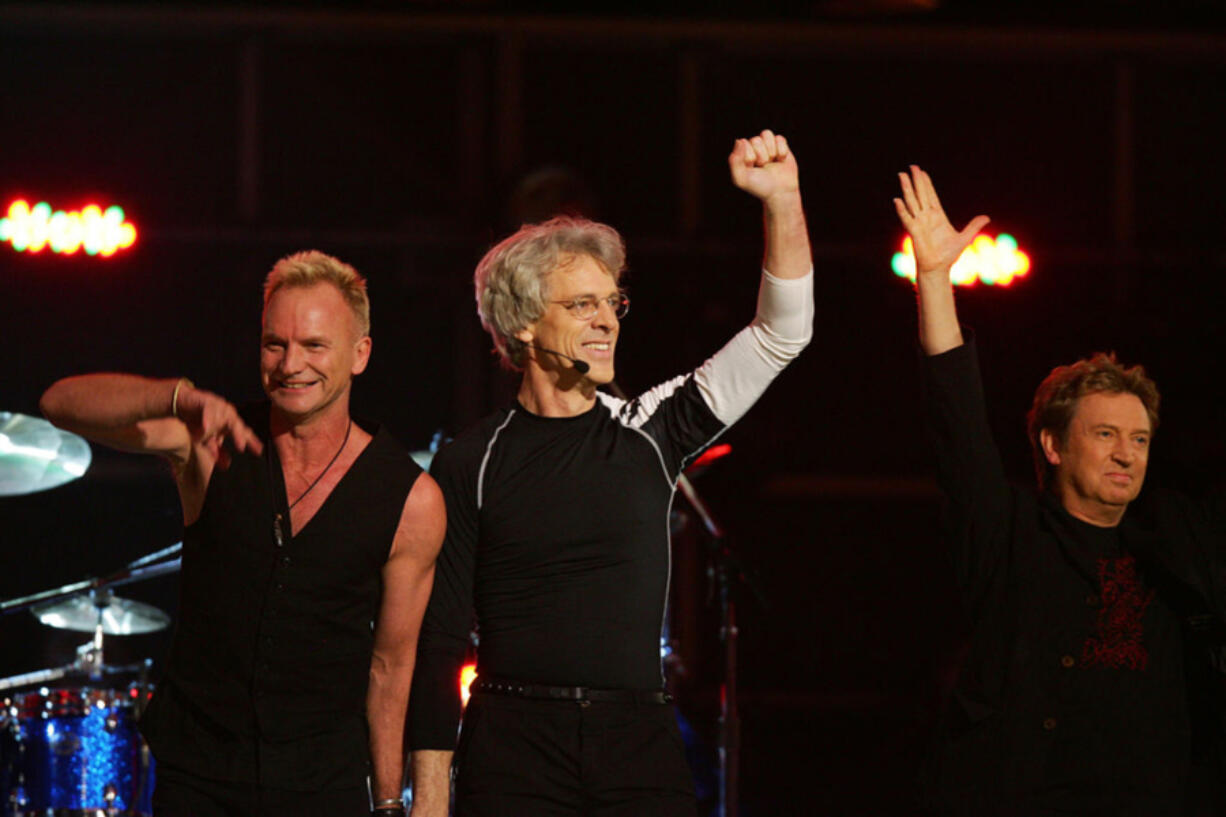 Singer Sting, from left, drummer Stewart Copeland and guitarist Andy Summers of The Police wave after performing at the 49th Annual Grammy Awards in Los Angeles on Feb. 11, 2007.
