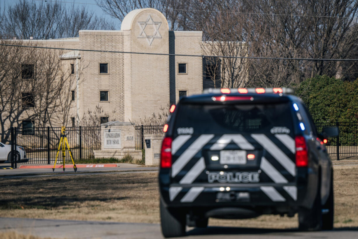 A law enforcement vehicle sits near the Congregation Beth Israel synagogue on Jan. 16, 2022, in Colleyville, Texas. All four people who were held hostage at the Congregation Beth Israel synagogue have been safely released after more than 10 hours of being held captive by a gunman.