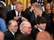 Comedian and activist Jon Stewart speaks to Jerry Ensminger, a Camp LeJeune survivor, during a signing ceremony for the PACT Act of 2022, in the East Room of the White House in Washington, D.C., on Aug. 10, 2022.